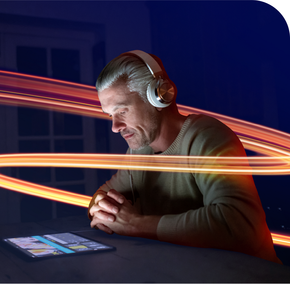 Man wearing headphones on his tablet watching the screen 