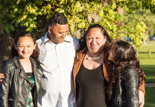 Photo of a Maori family with a mother, father and two daughters