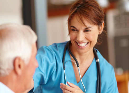 Photo of a nurse assisting an elderly gentleman