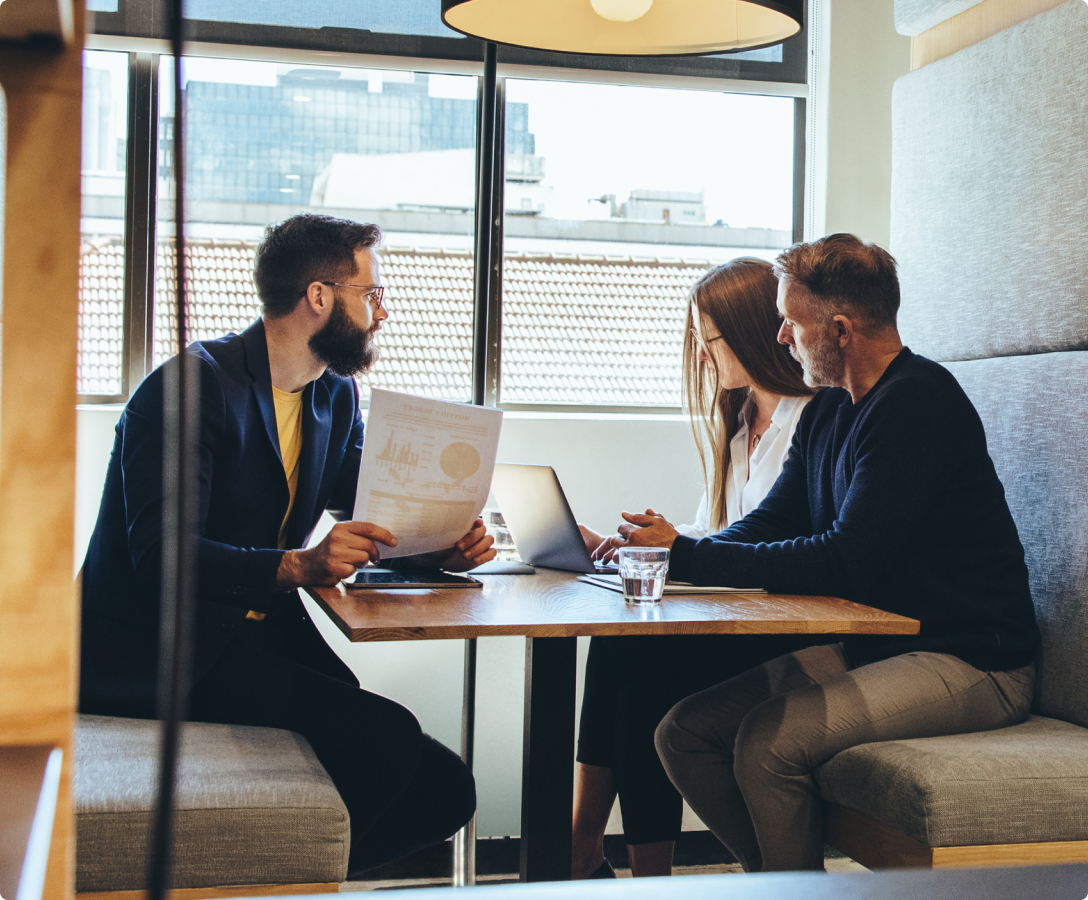 Business people sitting in a cubical having a meeting