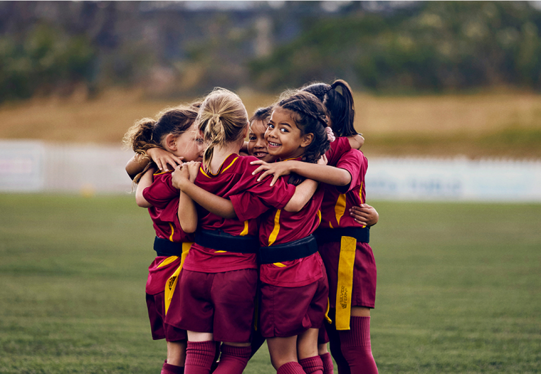 Young girl ripper rugby sport team in a huddle