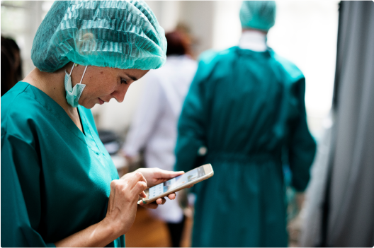 Image of a surgical worker on their mobile phone